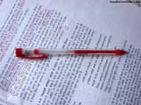 photos of a red pen on paper